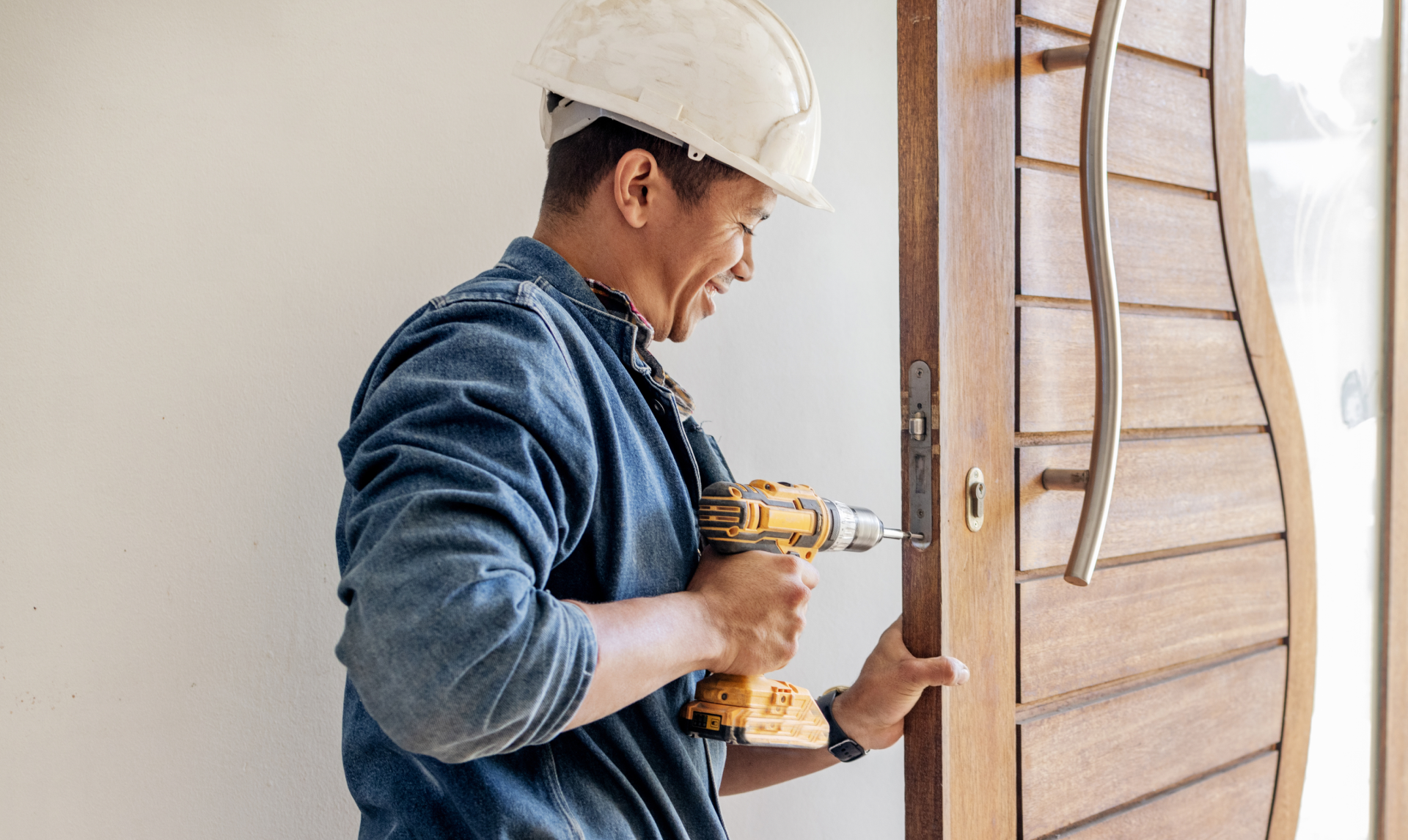 Man fixing door handle with tool