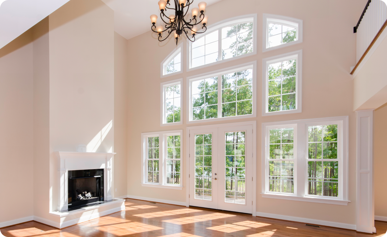 High ceiling room with fireplace and windows